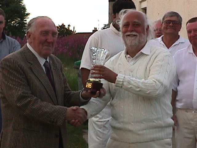 Ian Ormerod receives the trophy